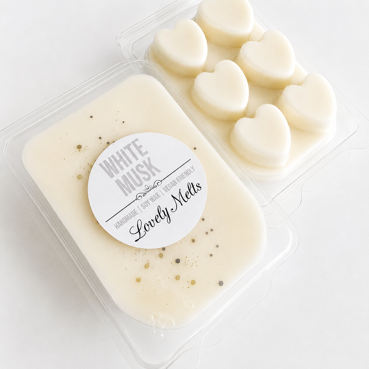 Packaged heart-shaped wax melts with a 'White Musk' label on a white background