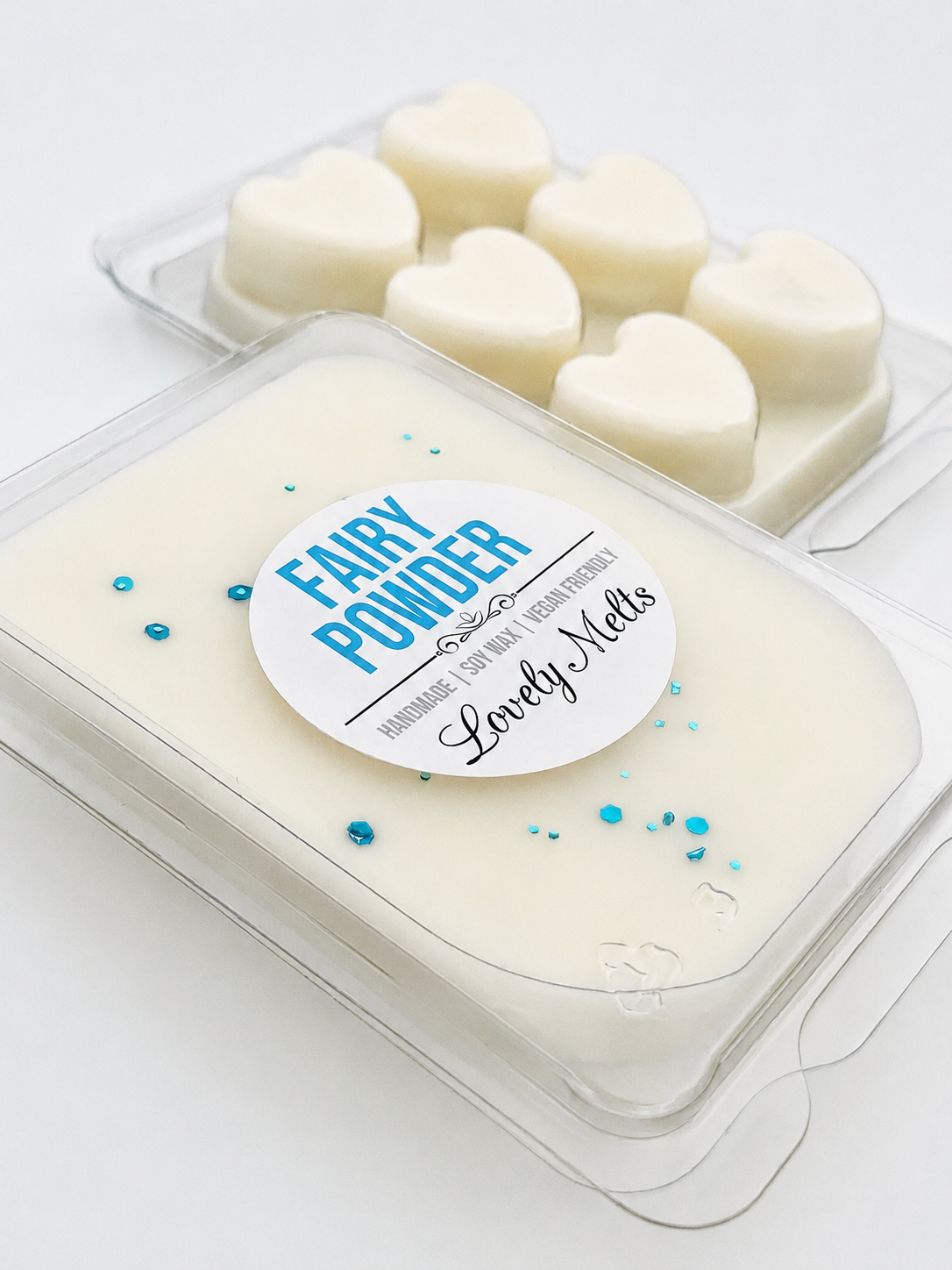 Heart-shaped wax melts in a container with 'Fairy Powder' label on a white background