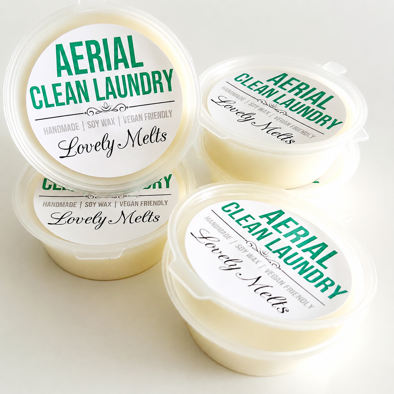 Three containers of Aerial Clean Laundry Lovely Melts on a light background