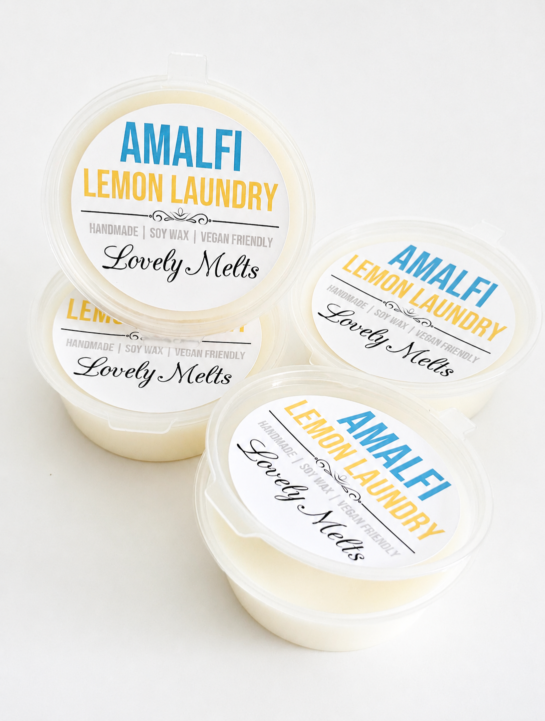 Four containers of 'Amalfi Lemon Laundry'wax melts with visible labels on a white background