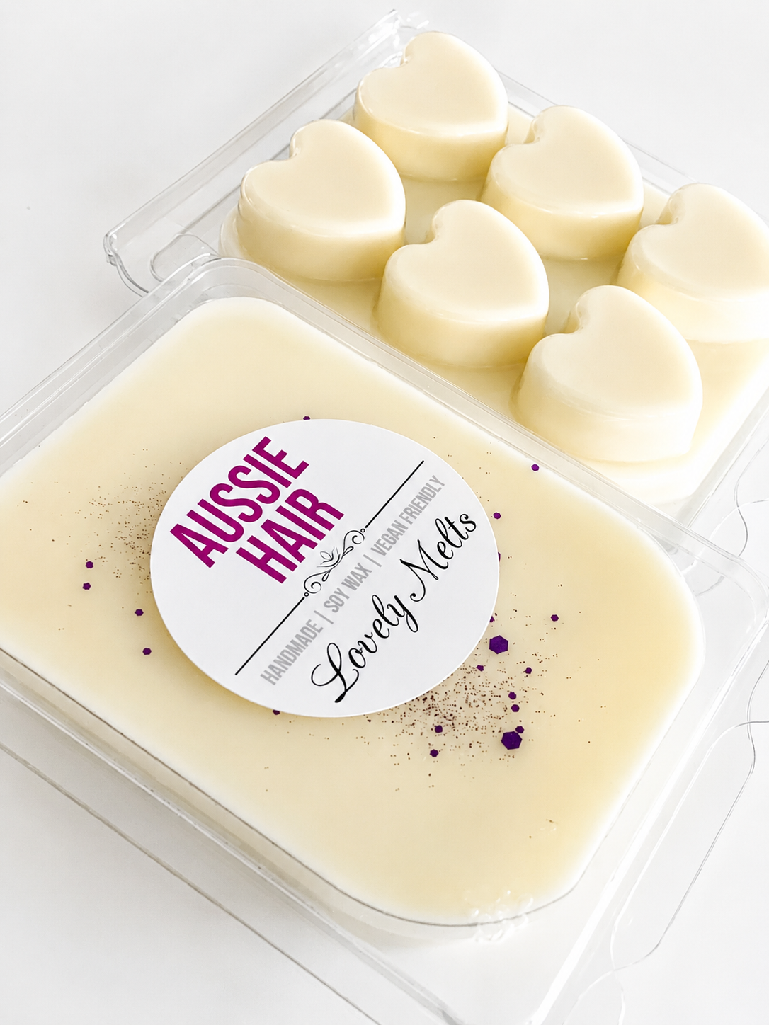 Heart-shaped wax melts in a container with 'Aussie Hair' branding on a white background