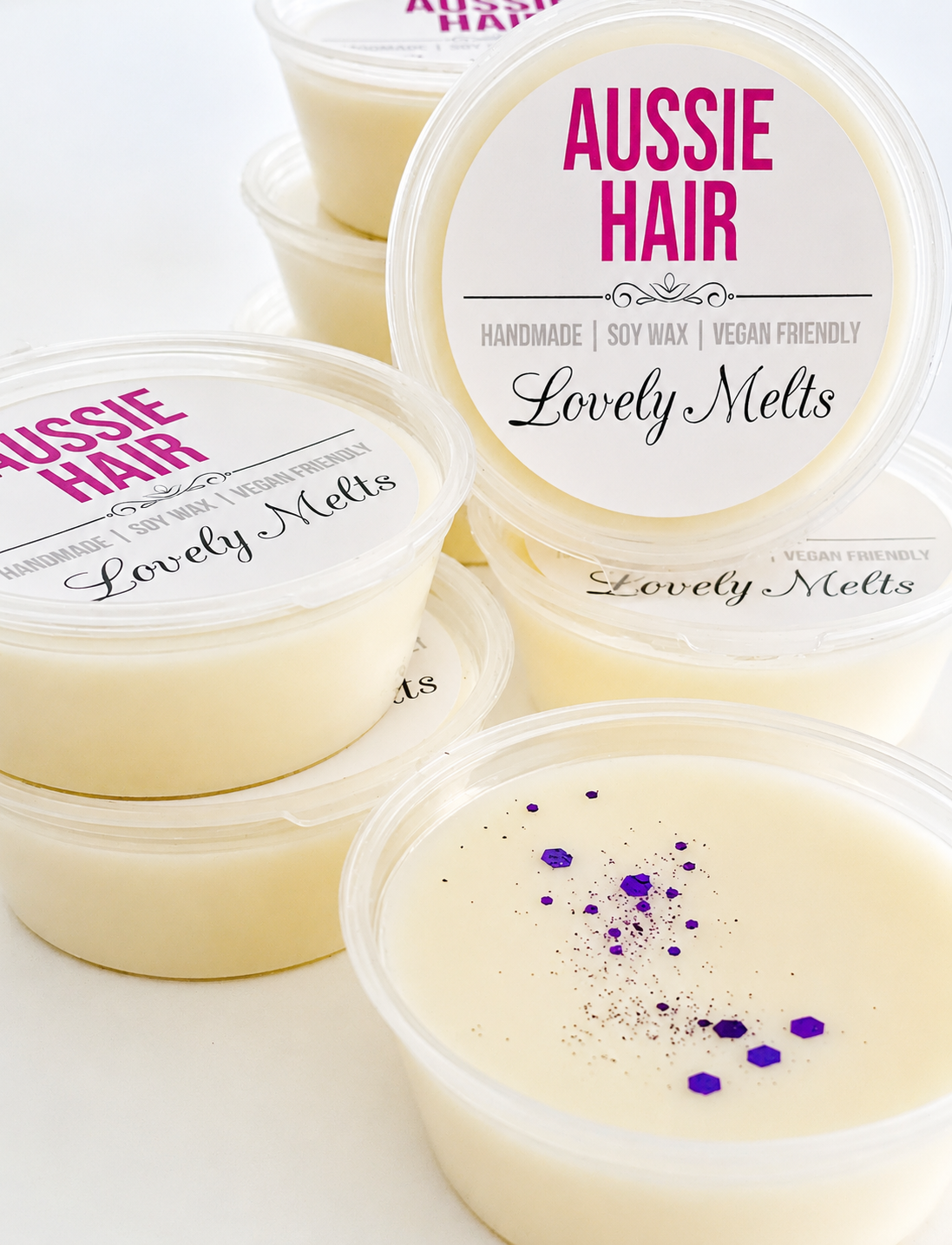 Aussie Hair Lovely Melts containers on a white background