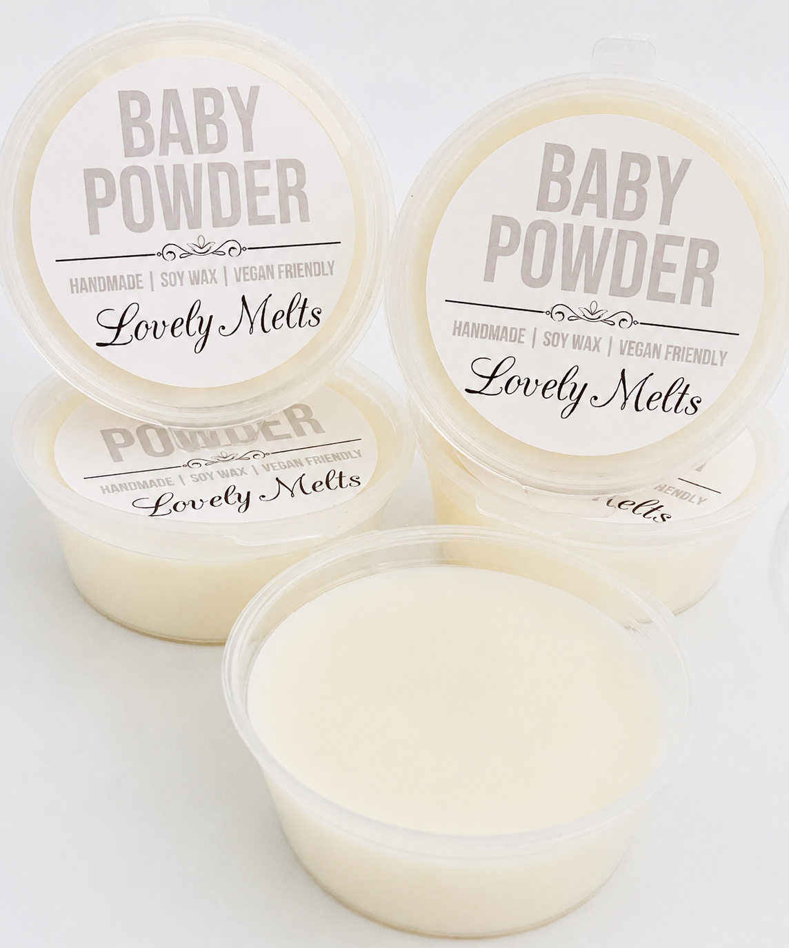 Three containers of 'Baby Powder' scented wax melts by Lovely Melts on a white background.