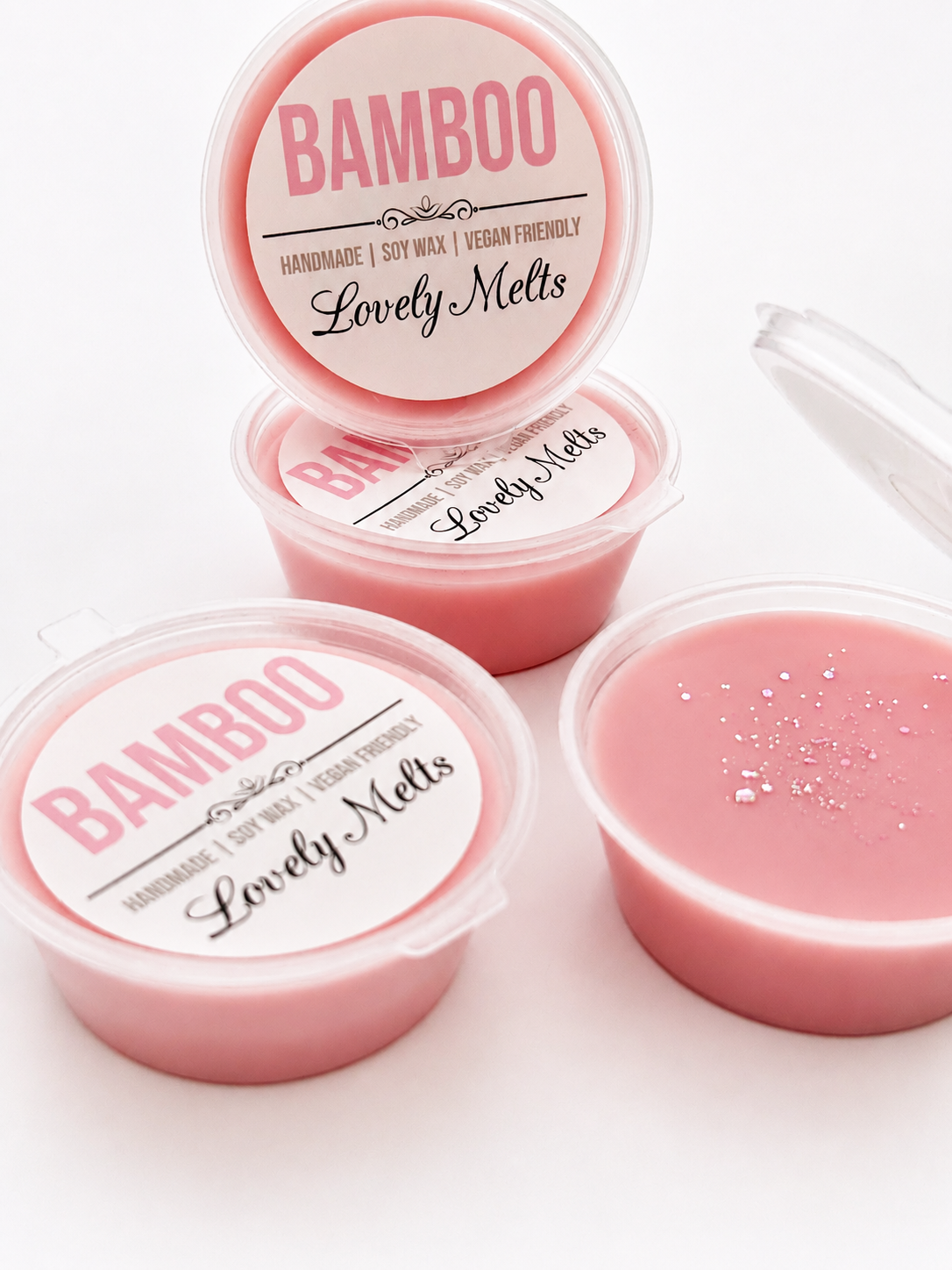 Pink wax melts in containers with 'Bamboo Lovely Melts' labels on a white background