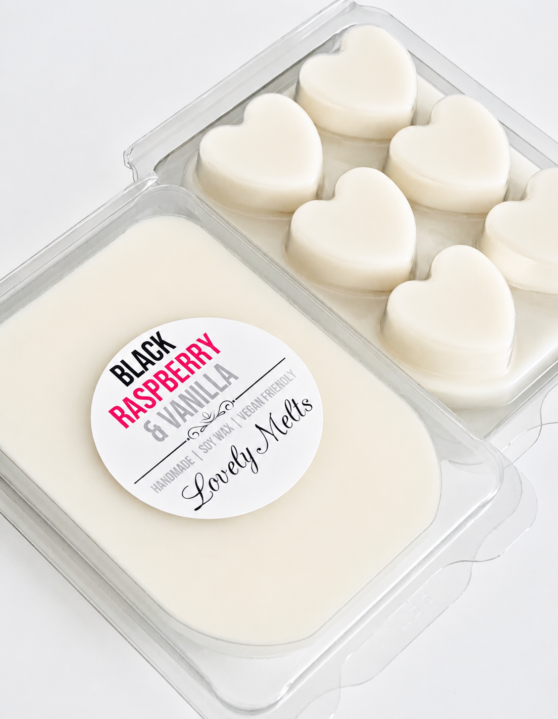 Heart-shaped white wax melts in a container with a 'Black Raspberry & Vanilla' label.