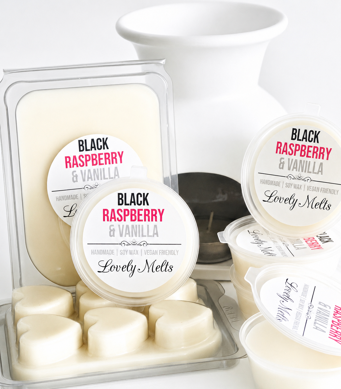 Black Raspberry & Vanilla Lovely Melts wax melts in packaging with a white wax burner and candle in the background