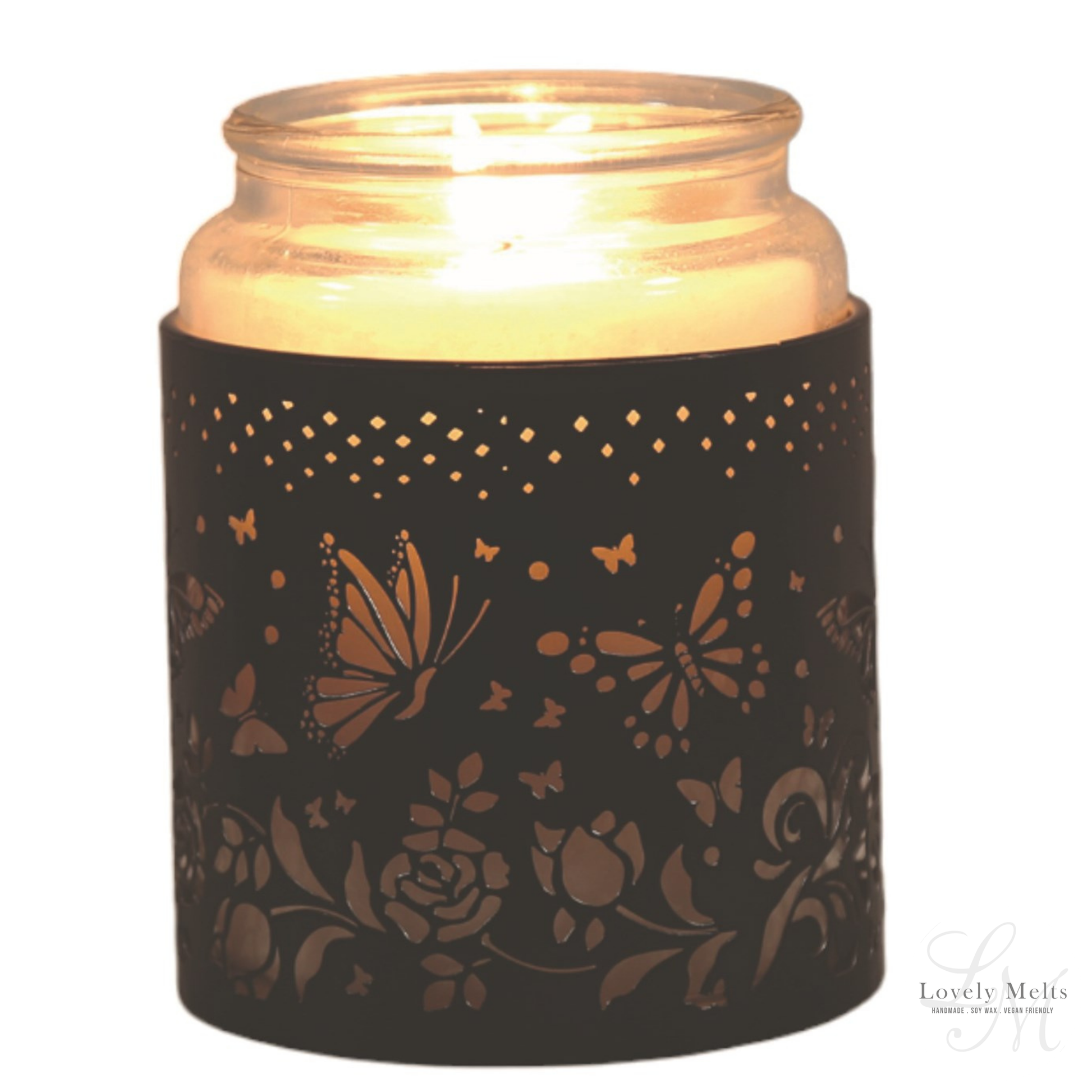Candle in a decorative black holder with butterfly and floral patterns on a white background.