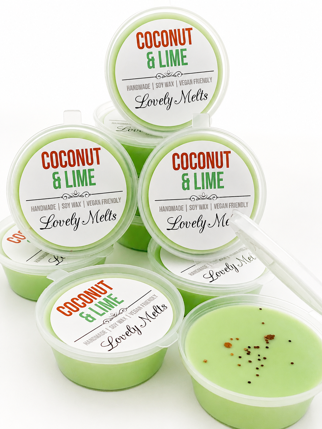 Green and white containers of Coconut & Lime wax melts made by Lovely Melts on a white background