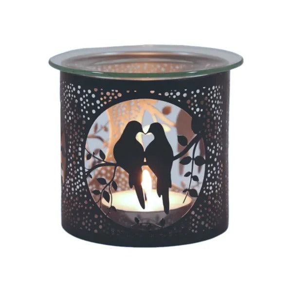 Candle warmer with cut-out design of two birds in a heart shape on a white background