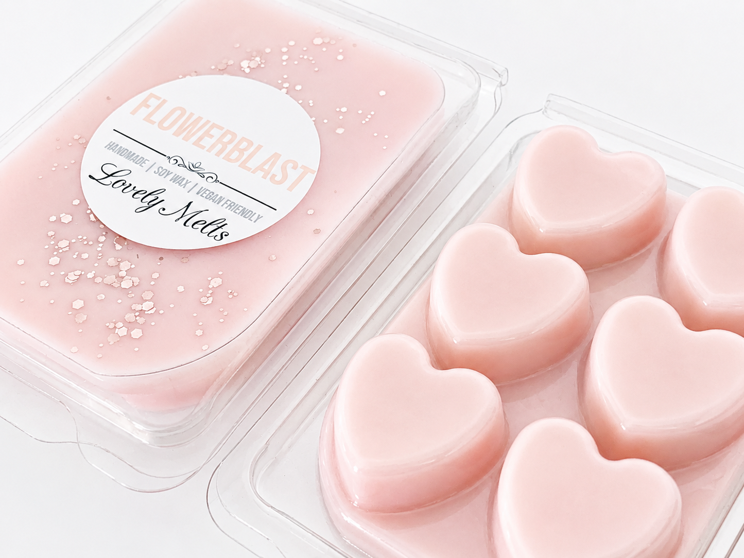 Heart-shaped pink melts in a clear container with a 'FLOWERBlast' label.