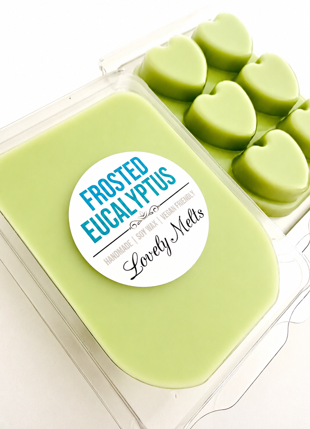 Green wax melts in a heart mold with a 'Frosted Eucalyptus' label on a white background