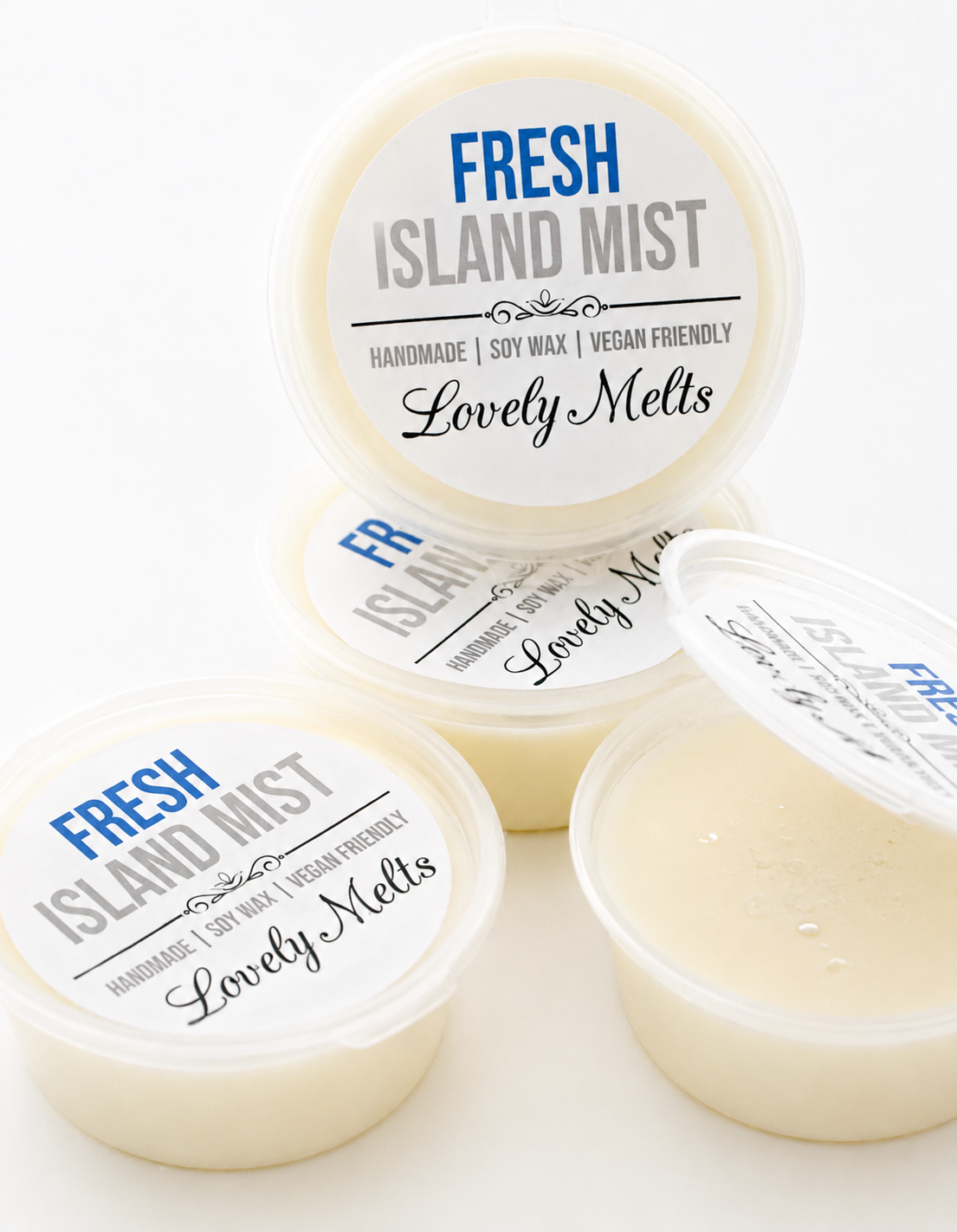 Three containers of 'Fresh Island Mist Lovely Melts' WAX MELTS on a white background