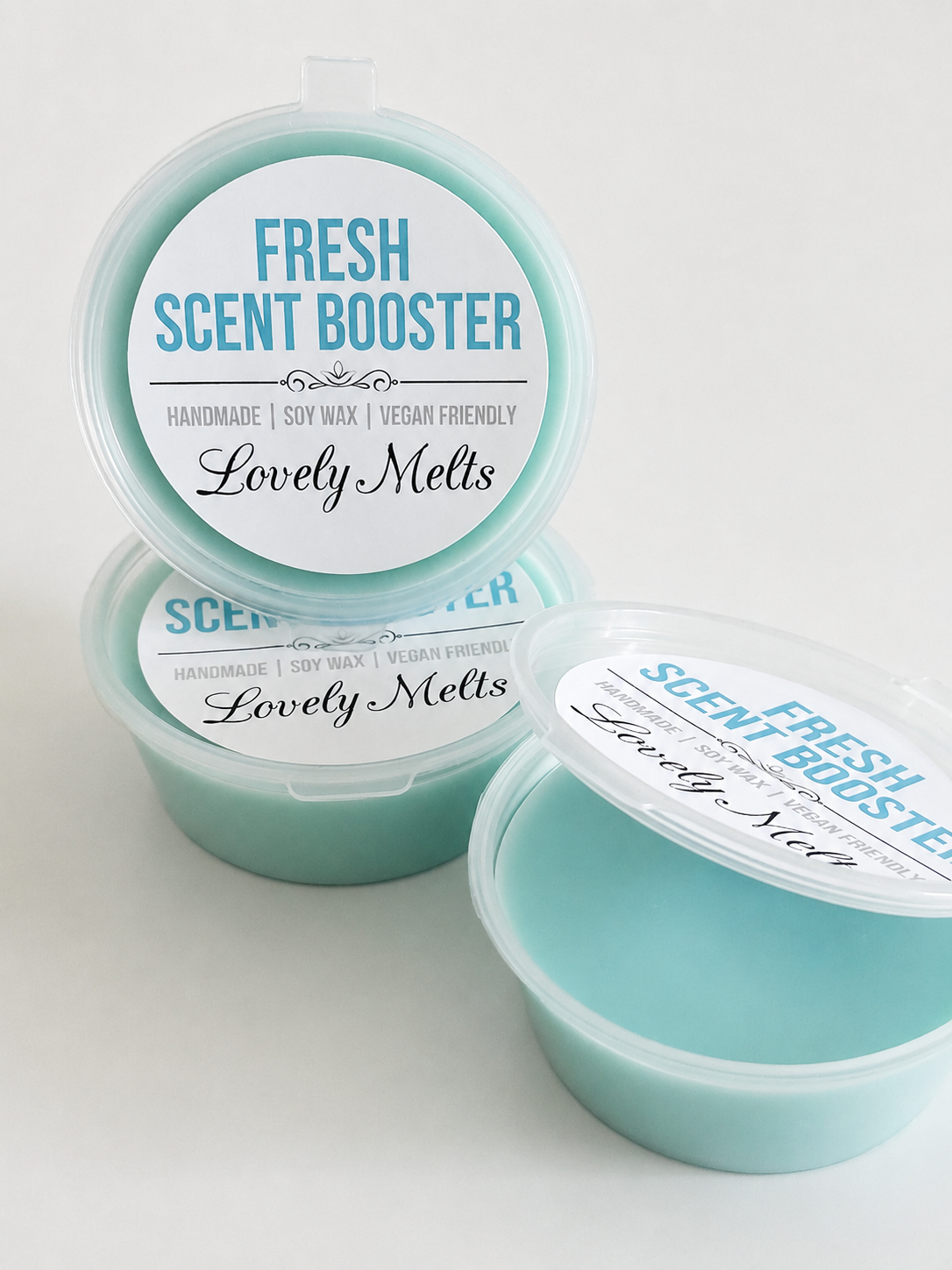Three containers of 'Fresh Scent Booster' wax melts by 'Lovely Melts' on a white background