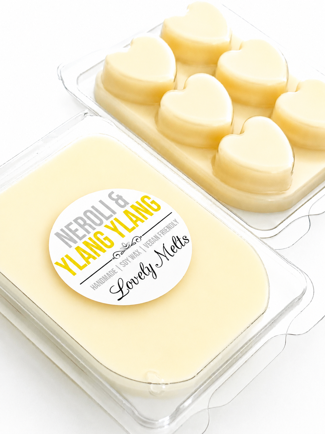 Heart-shaped wax melts in a clear container with a 'Neroli & Ylang Ylang' label.