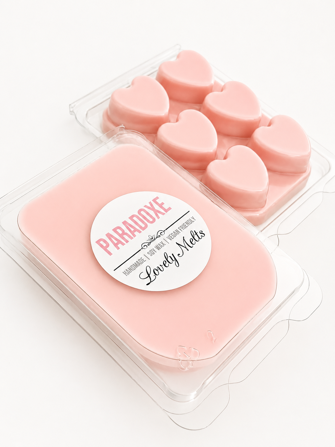 Packaged pink heart-shaped soap melts with 'Paradise Lovely Melts' label on a white background