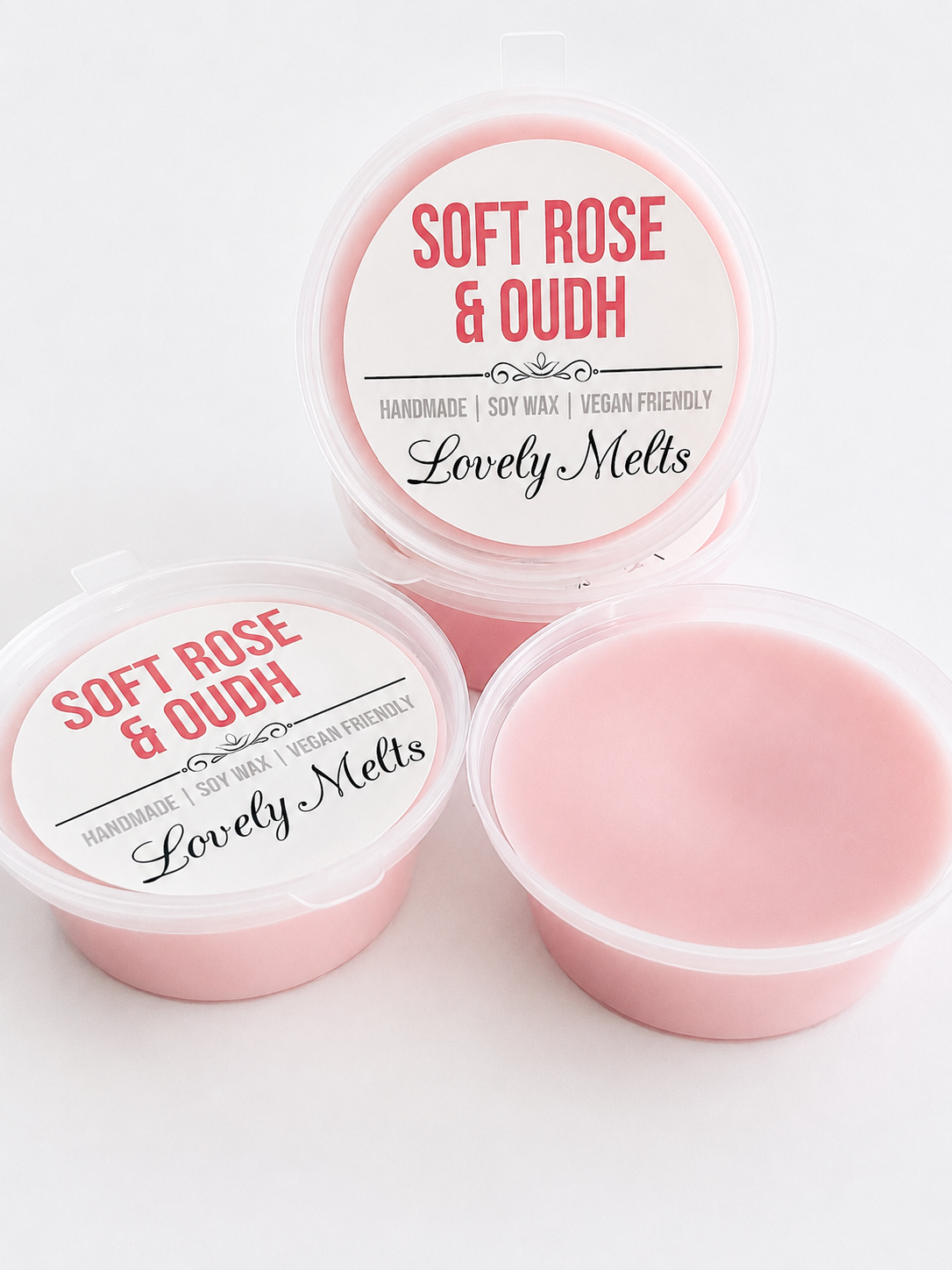Pink wax melts in containers with 'Soft Rose & Oudh' branding on a white background