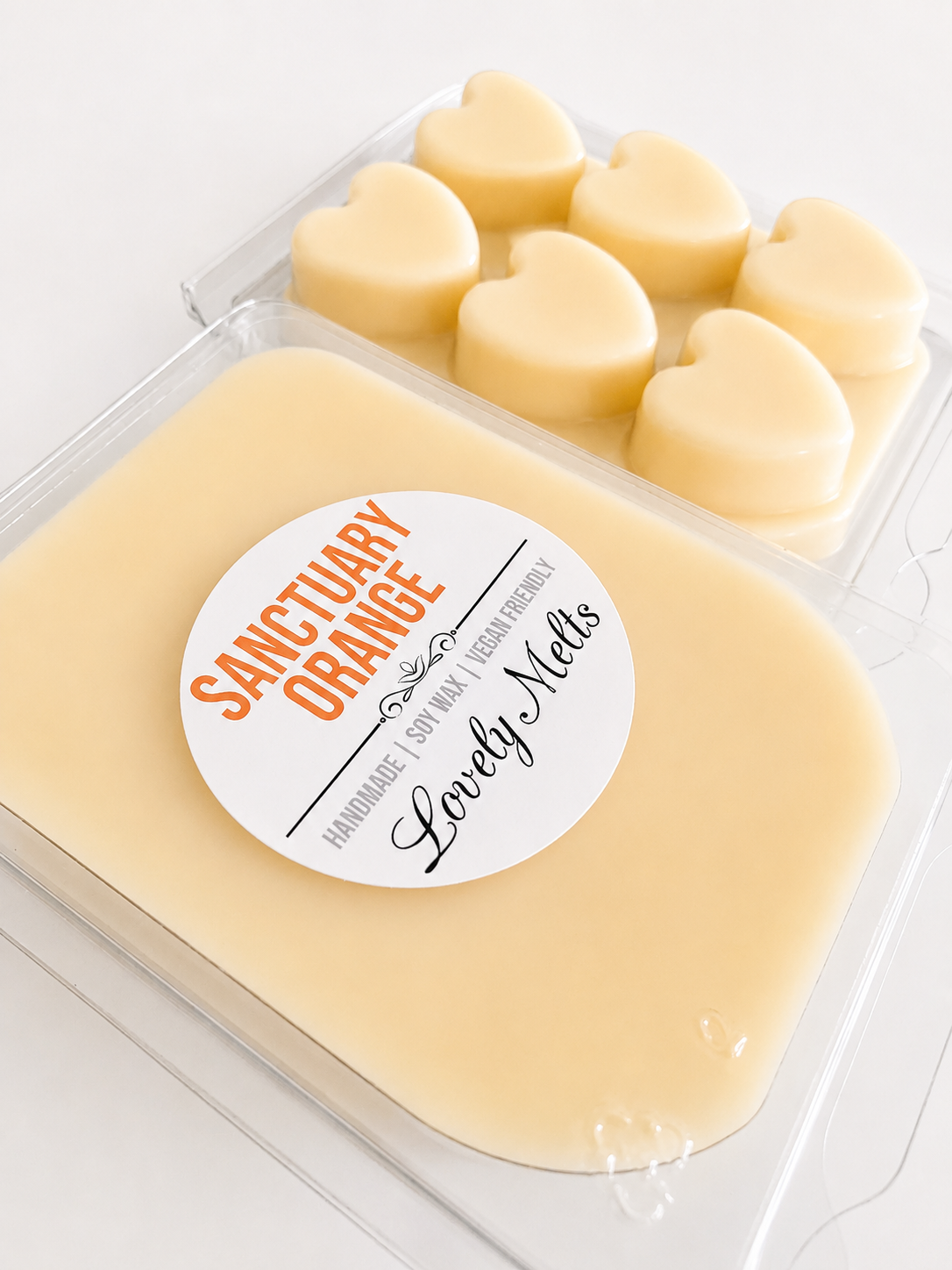 Packaged Wax Melts with a 'Sanctuary Orange' label on a white background