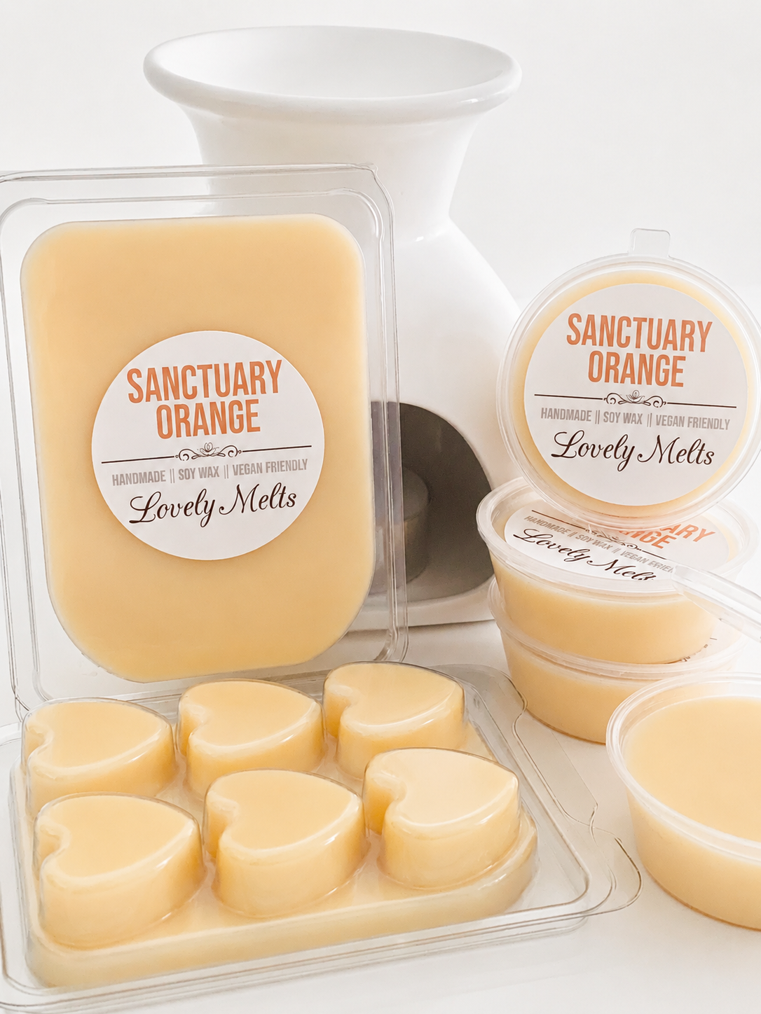 Packaged and open containers of 'Sanctuary Orange' wax melts on a white background