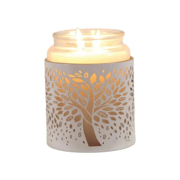 Candle in a decorative holder with tree design on a white background
