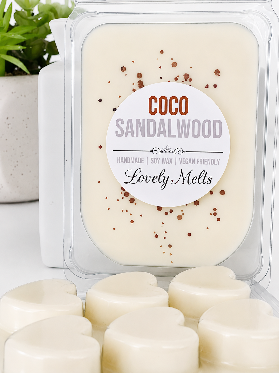 Coco Sandalwood wax melts in a clear packaging with a label on a light background.