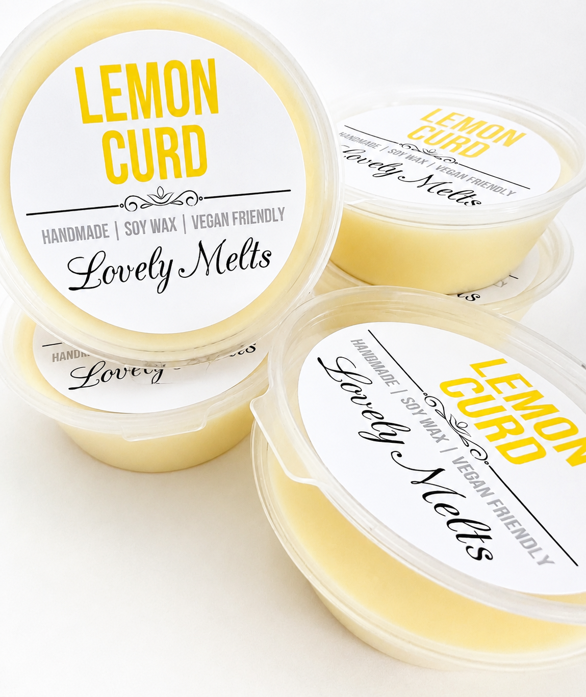 Three containers of Lemon Curd scented wax melts by Lovely Melts on a white background.