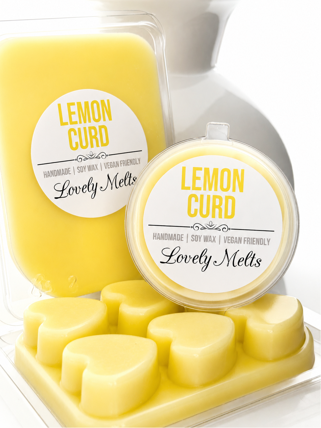 Yellow lemon curd-scented wax melts with 'Lovely Melts' packaging on a white background