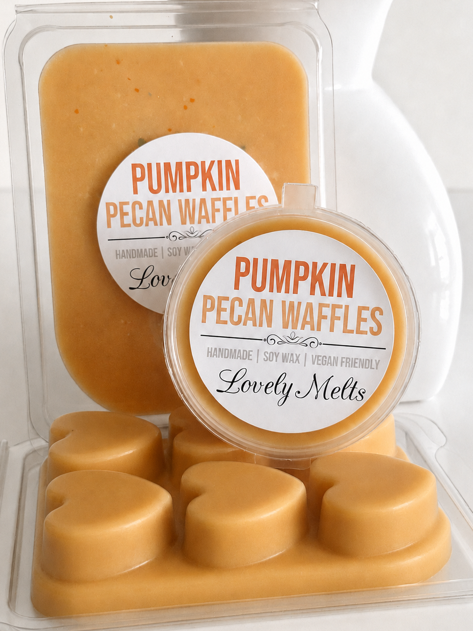 Pumpkin Pecan Waffles handmade soy wax melts by Lovely Mels, shown in a clear clamshell package and pot with a matching label, set against a white ceramic background.