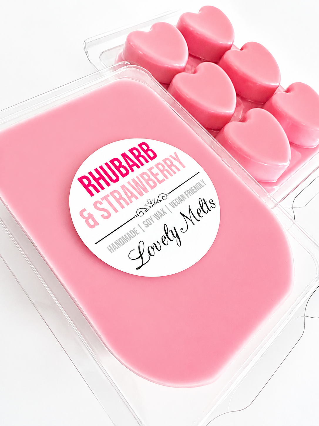Pink heart-shaped wax melts in a container with a 'Rhubarb & Strawberry' label.
