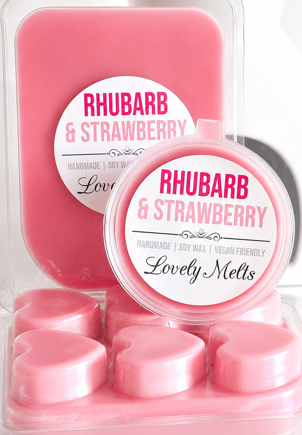 Pink rhubarb and strawberry wax melts in a clear container with a label.