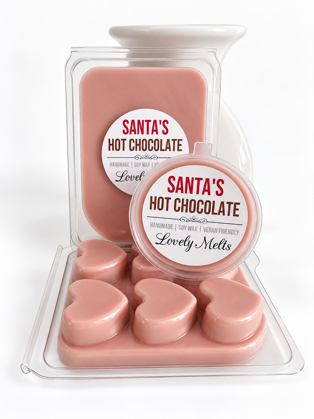A set of santas hot chocolate wax melts in heart-shaped wax pieces, shown in a clear plastic clamshell container with a white lid, alongside a matching round tub labeled 'Santa's Hot Chocolate' by Lovely Melts.
