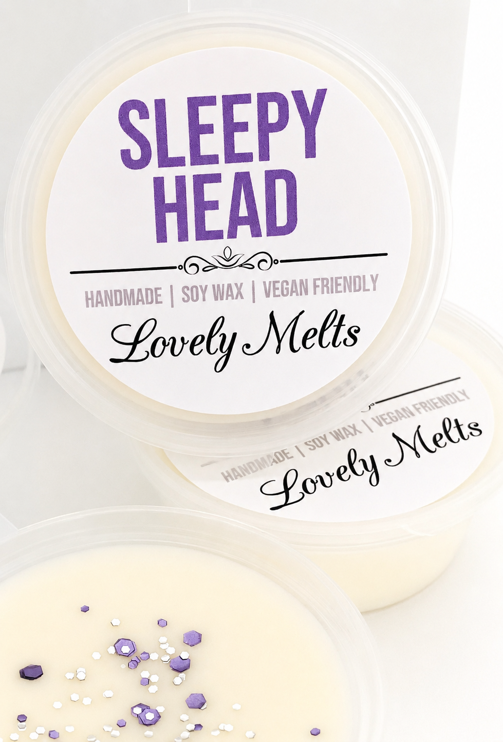 Two containers of 'Sleepy Head' and 'Lovely Melts' wax melts on a white background.