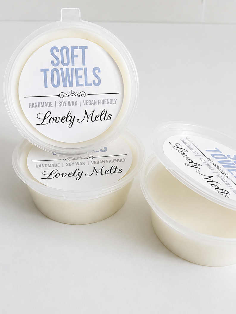 Three containers of 'Lovely Melts' soft towels wax melts on a white background